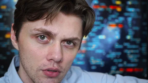 Portrait of a young professional man looking into the camera with a screen with Stock Footage 128439803