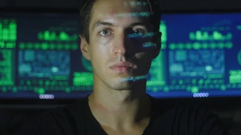 Portrait of a young programmer with a binary code on his face in a cyber office Video stock 80280615