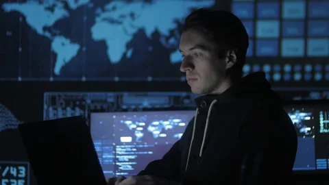 Portrait of a young programmer working at a computer in the data center filled Stock-Footage 86895956