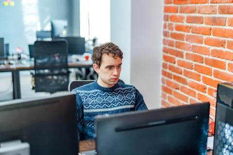 Portrait of young programmer working in office. Developing programming Stock Photos