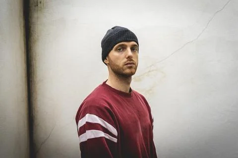 Portrait of young rapper posing in front of a white wall Stock Photos