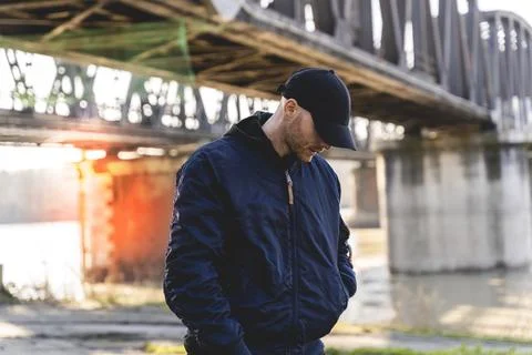 Portrait of young rapper posing under a metal bridge Stock Photos