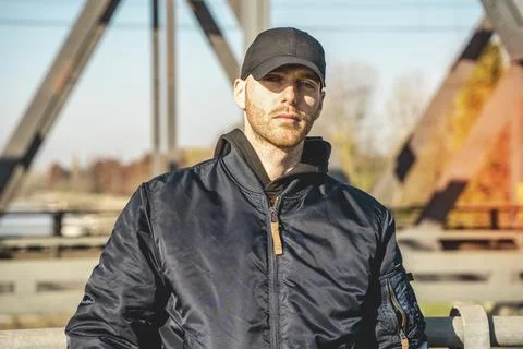 Portrait of young rapper posing under a metal bridge Stock Photos