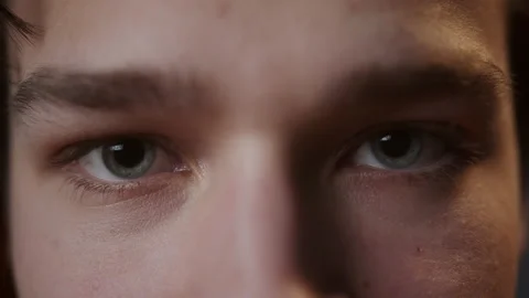 Portrait of young sad man with light blue gray eyes, looking in camera with Stock Footage 157075403