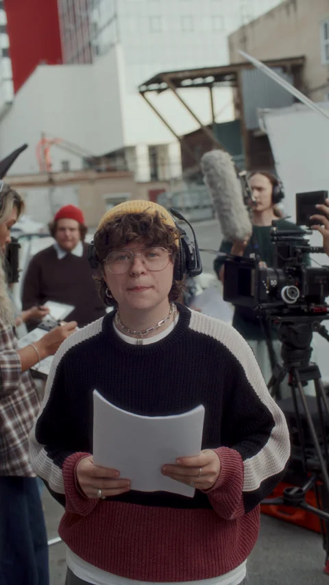 Portrait of Young Script Supervisor Holding Papers on Outdoor Film Set Vídeo Stock 336699766