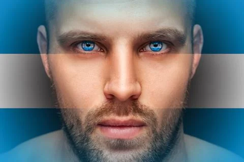 A portrait of a young serious man, in whose eyes the reflected national flag  Stock Photos