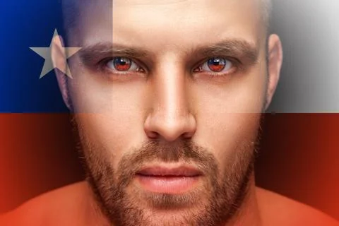 Portrait of a young serious man, in whose eyes the reflected national flag of Stock Photos