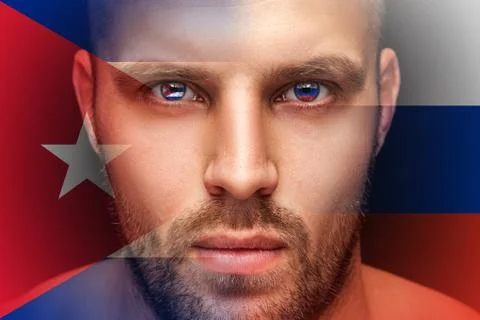 A portrait of a young serious man, in whose eyes are reflected the national f Stock Photos