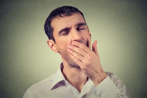 Portrait young sleepy man yawning. Sleep deprivation, burnout, laziness conce Stock Photos