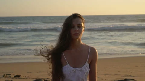 Portrait of a young slim long haired young woman stands on the shore along the Video stock 155282241