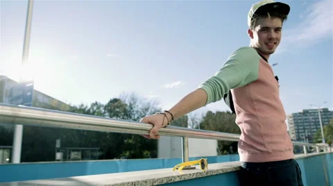 Portrait of a young smiling boy standing near a metal fence, oudoor Vídeo Stock 43222559