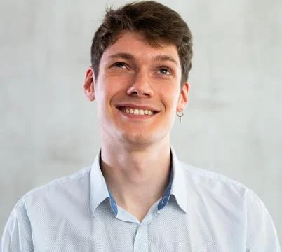 Portrait of young smiling guy in studio Stock Photos