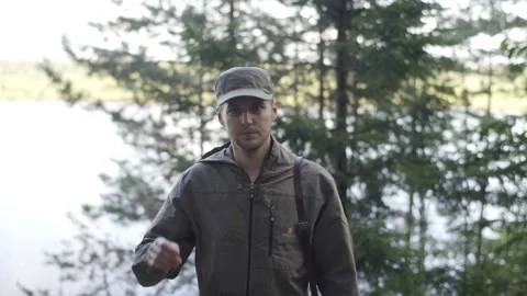 Portrait of Young Smiling Man Standing in Forest. Traveling Concept People in Stock Footage 133353680