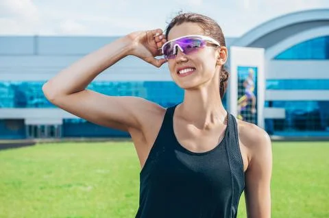Portrait of a young smiling runner posing at a football stadium. Sports con.. Stock Photos