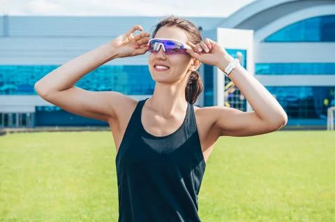 Portrait of a young smiling runner posing at a football stadium. Sports con.. Stock Photos