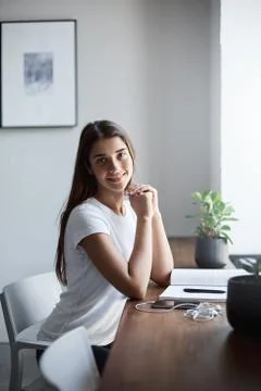 Portrait of young software engineer student reading a work book looking at Stock Photos