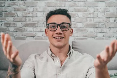 Portrait of young student talking to the camera in conference video call. Man Stock Photos