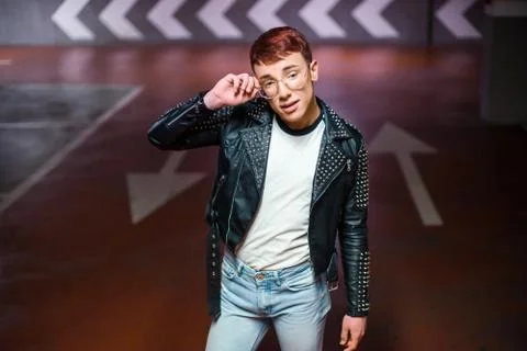Portrait of a young stylish boy posing on an underground parking Stock Photos