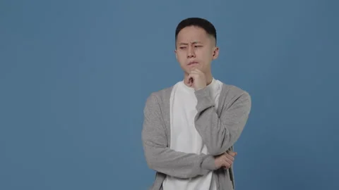 Portrait of a young thinking pondering man having an idea moment pointing a Stock Footage 254488140