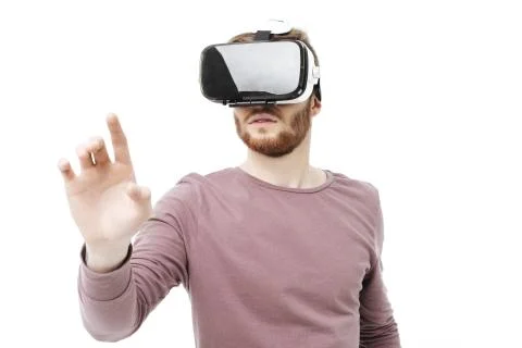 Portrait of young thoughtful man using virtual reality glasses on white Foto stock