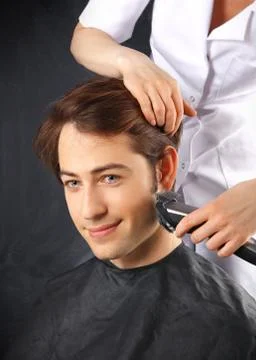 Portrait of a young white boy while cutting hair in the hair salon  Stock Photos