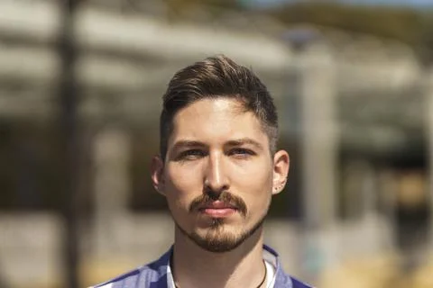 Portrait of young white man with beard, piercings and blue eyes Stock Photos