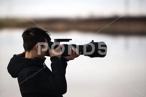 Portrait with young wildlife photographer in nature Stock Photos