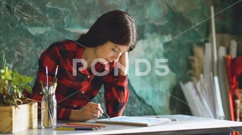 Portrait young woman artist painting scetch on paper notebook with pencil Stock Photos
