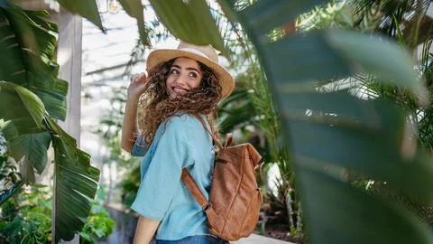Portrait of young woman in botanical garden. Stock Photos