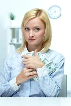 Portrait of a young woman clasping dollars to her bosom Stock Photos