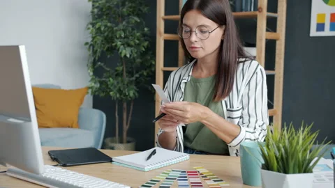 Portrait of young woman developing smartphone app using computer and graphics Video stock 158089156