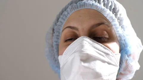 Portrait of a young woman doctor in a medical protective mask. COVID-19. Stock Footage