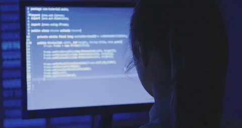 Portrait of young woman hacker programmer working at a computer in the data Stock Footage 95752487