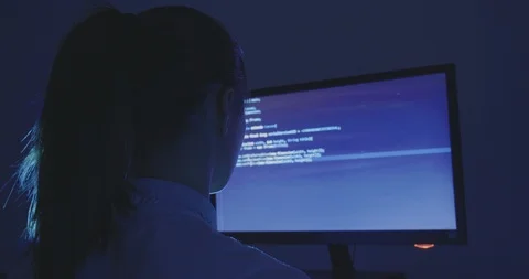 Portrait of young woman hacker programmer working at a computer at night in data Stock Footage 95922273