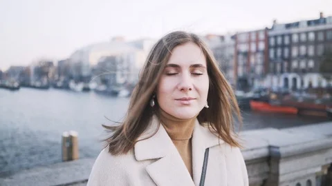 Portrait of a young woman mysteriously looking into camera in Amsterdam Stock Footage