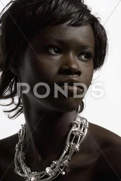 Portrait of young woman in necklace Stock Photos