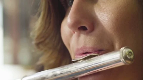 Portrait of young woman playing a flute Stock-Footage 77336053