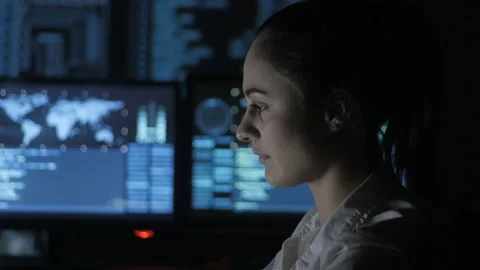 Portrait of young woman programmer working at a computer in the data center Stock Footage