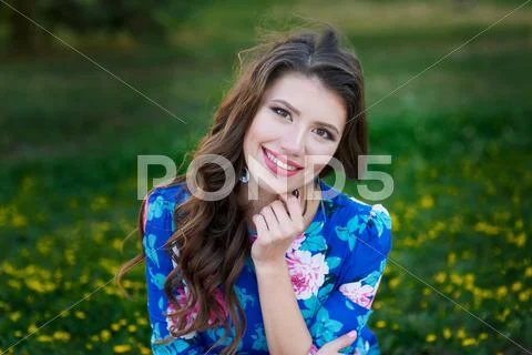 Portrait of young woman rest in the park smiling on the grass Stock Photos