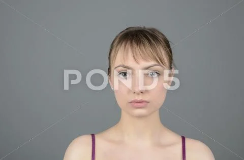 Portrait of young woman serious, close up Stock Photos