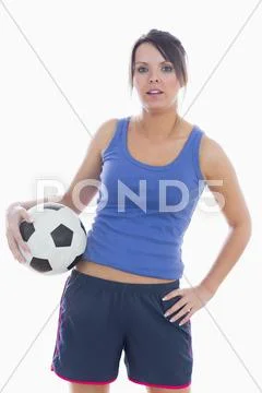 Portrait of young woman in sportswear with football Stock Photos