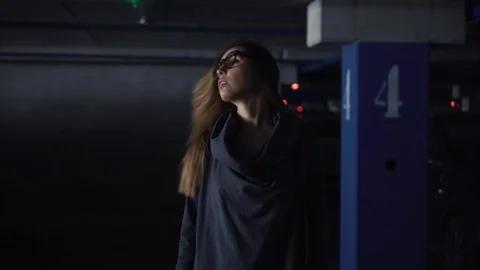 Portrait of a young woman in stylish glasses on a parking lot Stock Footage