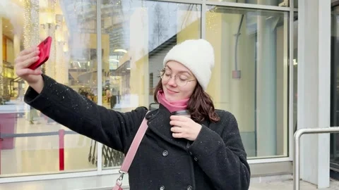 Portrait of a young woman using on a mobile phone. she make selfie outside .. Stock Footage 320346972