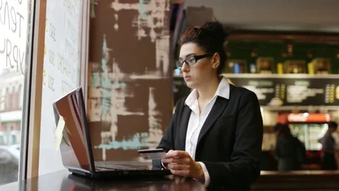 Portrait of Young Woman Using Smart Phone in a Cafe by the Window. Stock-Footage 82876004