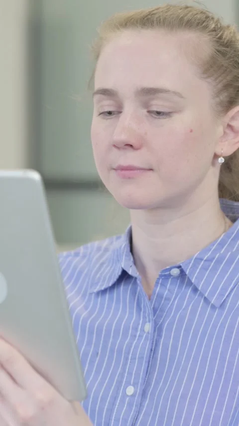 Portrait of Young Woman using Tablet Computer, vertical video Stock Footage 328553603