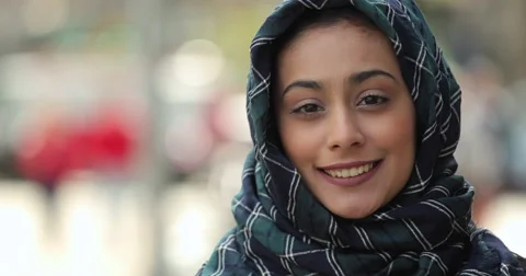 Portrait Young woman wearing hijab in city serious to smiling face people Stock Footage