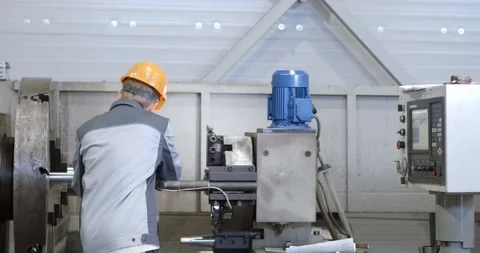 Portrait of a young worker in a helmet at a large metalworking plant. An enginee Stock Footage 149032779