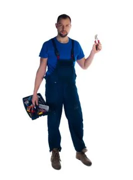 Portrait of a young worker with toolbox standing on white background Foto stock