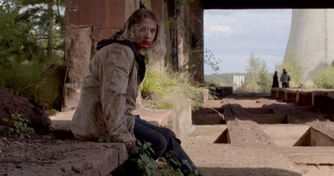 Portrait zombie man making jerky movements sitting destroyed building apocalypse Stock Footage 218982816