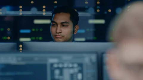 Portraits of Two IT Specialists Working on Personal Computers with Sophisticated Stock Footage 103516787